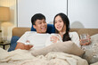 © bongkarn - A caring Asian husband is talking with his beloved wife before going to bed together.