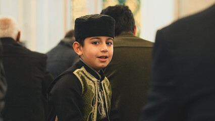 Wall Mural - Muslim young boy wear a beauty Muslim prayer cap at Mosque.