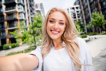 Sticker - Selfie photo of blonde blogger recording video her travel vlog around cities different countries demonstrate architecture design outdoors