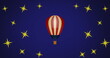 Image of hot air balloon over stars on blue background