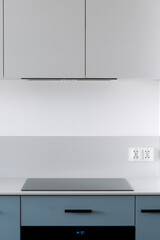 Sticker - Glass ceramic induction stove and integrated range hood in modern kitchen