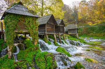 Old small wooden water mills called Mlincici built on Pliva lake near Jajce, Bosnia and Herzegovina.