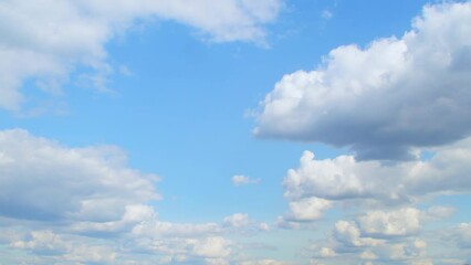 Wall Mural - Landscape with a panorama of white cumulus clouds slowly floating across the sky. Romantic summer sky.