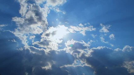 Wall Mural - Calm daytime sky with clouds and rays of light in bright tones.