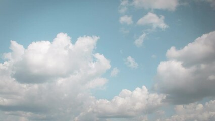 Wall Mural - Landscape with slow moving white cumulus clouds. Blue sky with several layers of clouds.