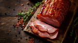Fototapeta Kwiaty - Delicious smoked ham on a wooden board with spices.