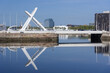 View of a modern steel swing bridge with a span of 35m build in 2006 and reflections on the water.