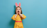 Fototapeta Tulipany - child wearing bunny ears on Easter day