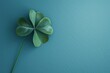 a four leaf clover on a blue surface