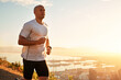 © Katie/peopleimages.com - Fitness, running and man on hill at sunset for health, wellness and strong body development. Workout, exercise and runner on path in nature for marathon training, performance and outdoor challenge.
