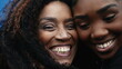 Happy African American mother and daughter's close-up faces in cheek to cheek portrait embrace, authentic and genuine loving bonding moment between parent and offspring