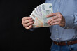Businessman holding banknotes in his hand. Czech Republic cash.