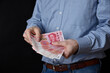 Businessman holding banknotes in his hand. Chinese RMB cash.