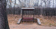 wooden bench in an autumn park with a roof