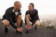 © Katie/peopleimages.com - Running shoes, love and couple in a road for fitness, training or morning cardio in nature together. Sneakers, shoelace and sports runner people outdoor for marathon, routine or performance workout