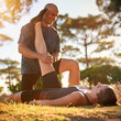 © Katie/peopleimages.com - Forest, stretching and woman with man for fitness, workout coach and help for healthy body. Exercise, wellness and girl athlete with personal trainer in muscle warm up for outdoor training in morning