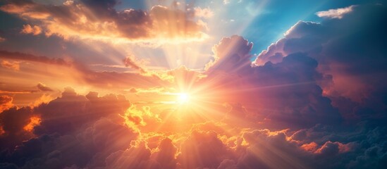 Wall Mural - Vivid sun rays breaking through fluffy white clouds in a breathtaking scene of nature's beauty
