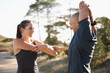 © Katie/peopleimages.com - Fitness, forest and couple stretching arms for workout, commitment and healthy body. Exercise, man and woman in muscle warm up for training, performance and morning in woods with personal trainer.