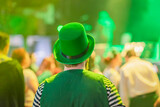 Fototapeta Młodzieżowe - Rear view of man wearing a green national hat celebrating St. Patrick's Day