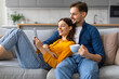 © Prostock-studio - Young spouses relaxing with tablet and coffee on sofa