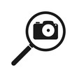 Camera icon in a magnifying glass. Vector illustration