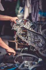 Wall Mural - A mechanic is assembling a motorcycle engine.