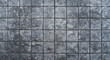 Black paving stones. Paving surface road. Texture made of big gray tile top view 
