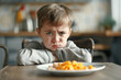 A kid refusing to eat breakfast looking unhappy with a little bit of food on the plate