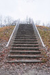 stone staircase up with metal railings in autumn