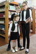 © Pavel Losevsky - Three students, two girls and boy looking in book that holds eldest girl