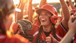 Closeup photo of a softball players celebrating a victory in the evening with fans in the background