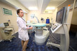 © Pavel Losevsky - Doctor stands about setting lithotripter in a cabinet