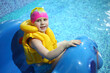 © Pavel Losevsky - Little girl in a swimming hat and life jacket on a hill in the pool