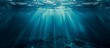 Underwater seascape with rays of sunlight piercing through, signifying the beauty and mystery of ocean depths.

