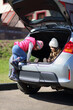 © Pavel Losevsky - Little girl and boy playing in open trunk of foreign car