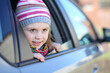 © Pavel Losevsky - Portrait of little girl in striped hat looking out car window