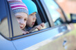 © Pavel Losevsky - Little girl in striped hat and boy looking out car window
