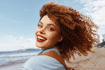 Wall Mural - Smiling Woman on Beach, Embracing Freedom and Happiness in a Wide Angle Lens Portrait