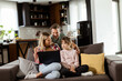 © BGStock72 - Family Bonding Time With Laptop in Cozy Home Setting