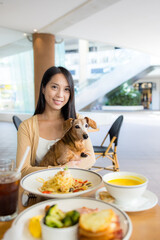 Poster - Woman go to restaurant with her dog in shopping center