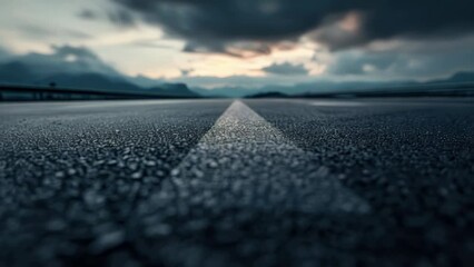 Poster - An empty asphalt road with mountains in the background. Suitable for travel and adventure concepts.