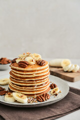 Wall Mural - Plate of maple pecan pancakes with fresh bananas