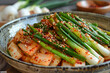 A kimchi with green onion in a plate, close up. Food background.