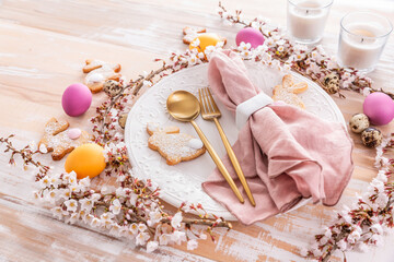 Wall Mural - Easter table setting with colorful eggs and bunny cookies