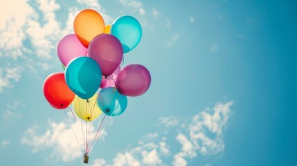 Colorful balloons floating in blue sky background