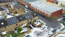Aerial Drone Footage Of A Typical British Housing Estate In The Town Of Bradford In The Winter Time With A Small Amount Of Snow On The Ground.