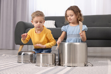 Sticker - Little children pretending to play drums on pots at home