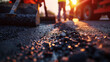 Road construction workers using paving equipment to repair asphalt street.