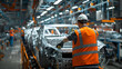 © DigitaArt.Creative - a man in an orange vest working on a car in a factory
