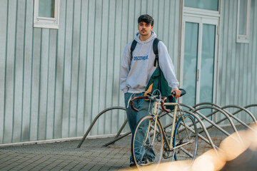 Poster - urban scene of young man with vintage bicycle